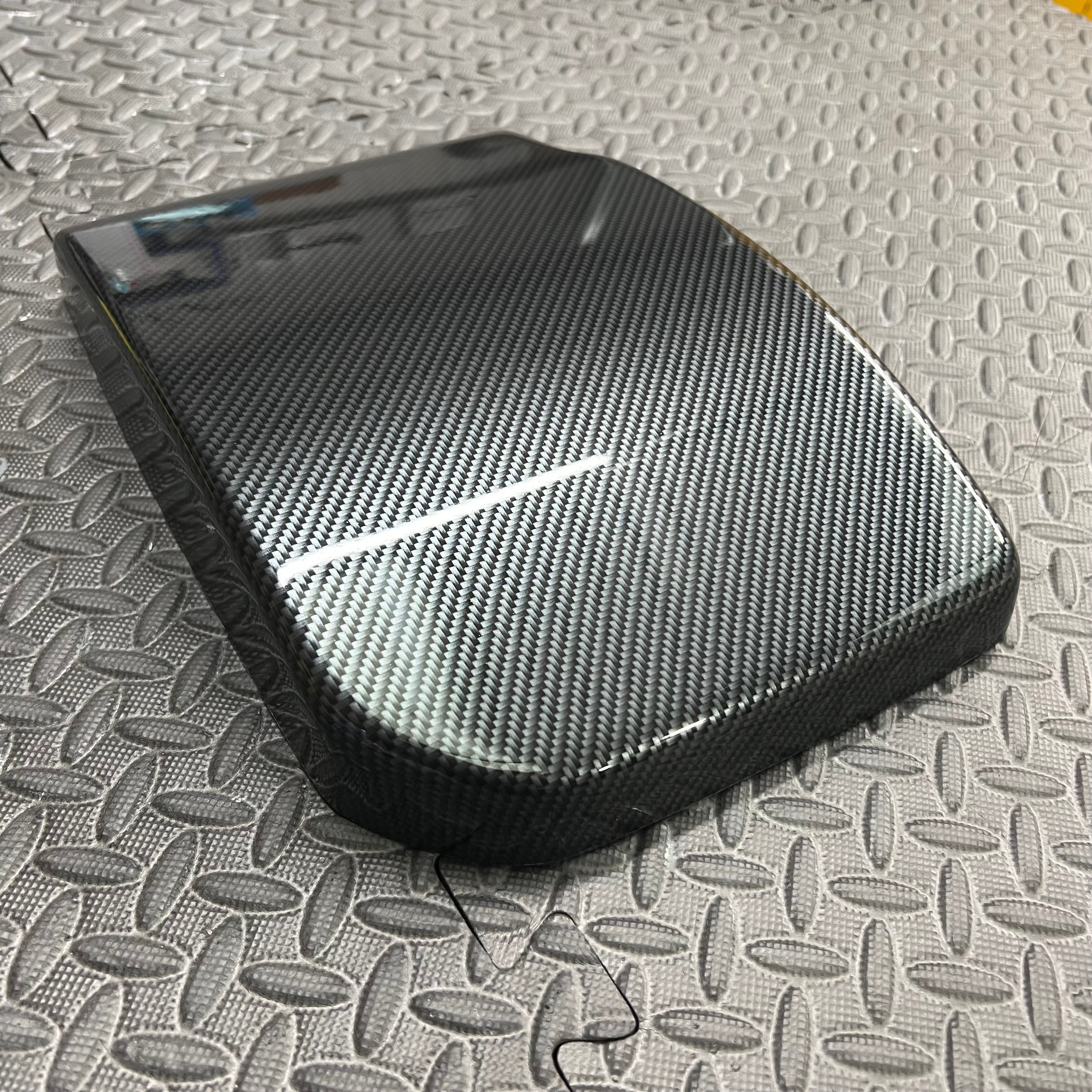 A black Proform engine bay battery cover fitted on a Ford Focus, showing the cover's placement in the vehicle's engine compartment.
