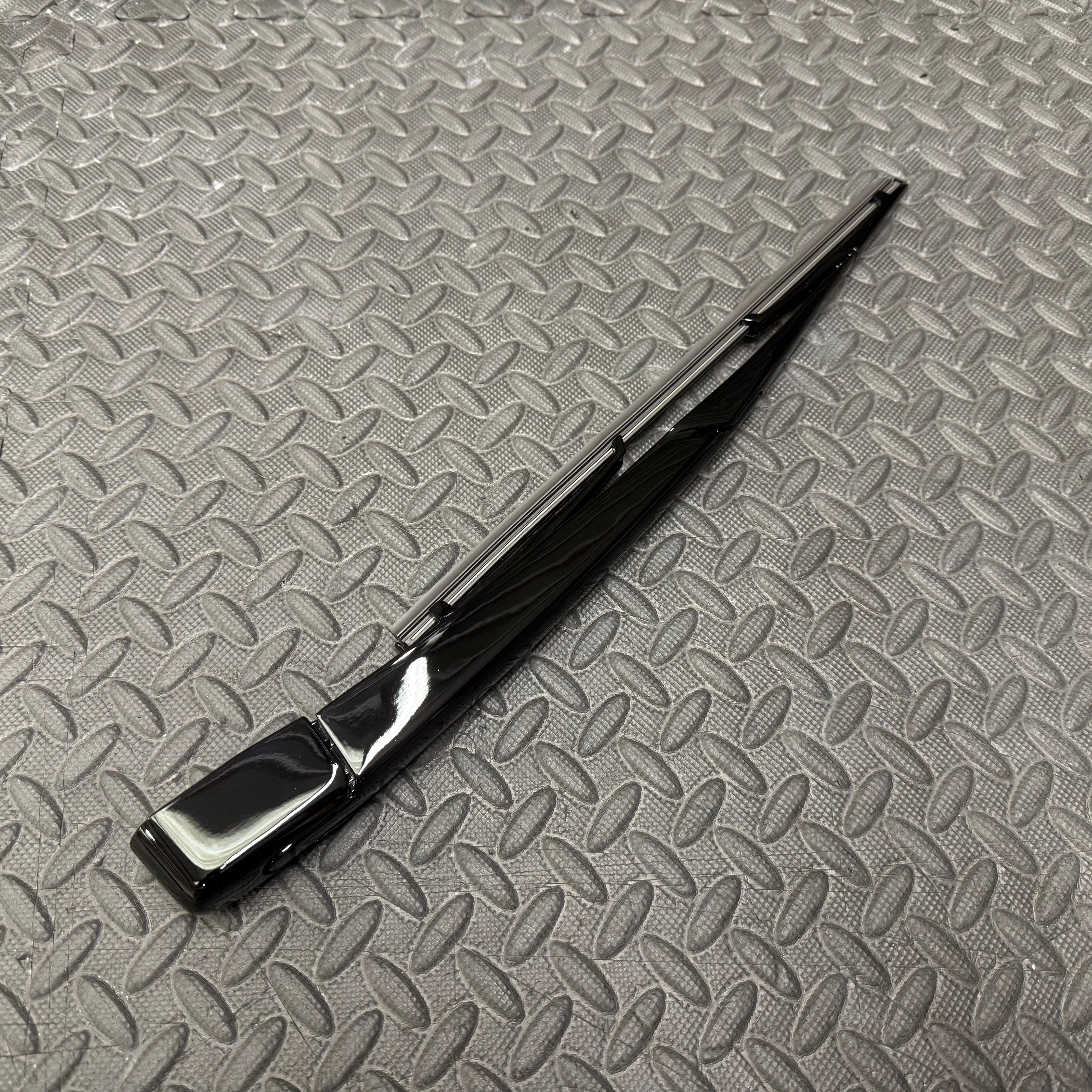 Black wiper blade on a textured gray surface
