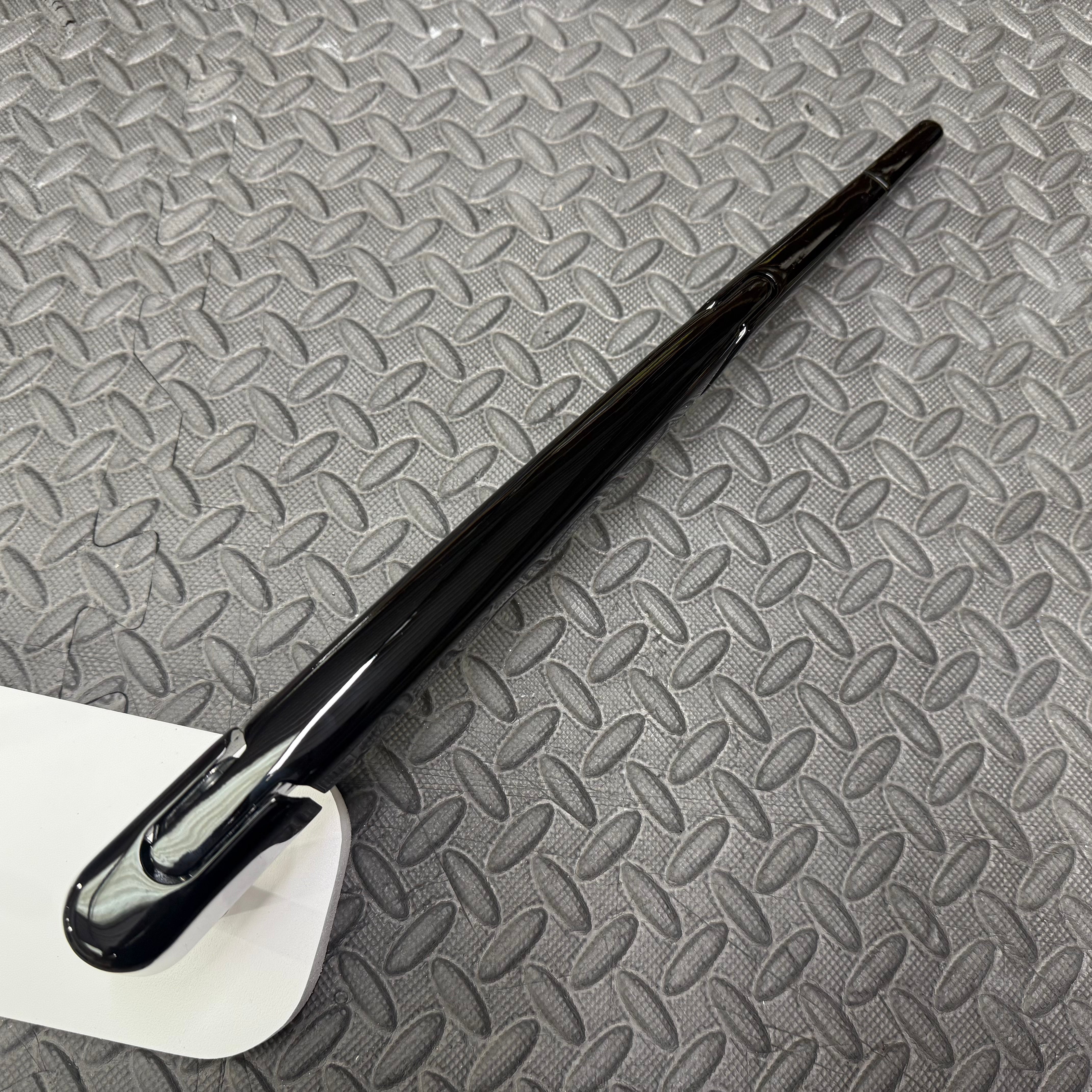 Black Fiesta wiper blade on a textured gray surface