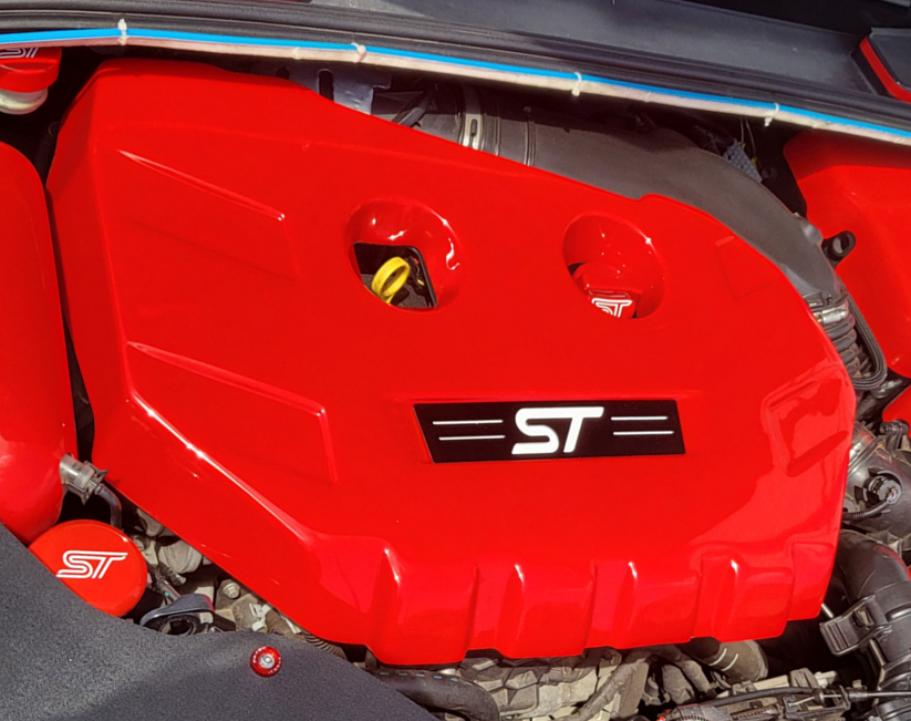 A Proform engine cover designed for a Mk3/3.5 Focus ST Petrol, featuring a carbon fibre effect plastic finish with a badge plate displaying the ST model designation.