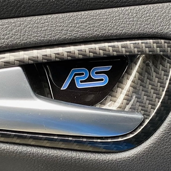 Car door panel with RS logo on a textured surface